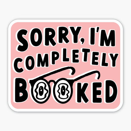 Pink square sticker with white trim. Black text saying, “Sorry, I’m Completely Booked”. Image of reading glasses to replace the 2 letter “O” in booked.