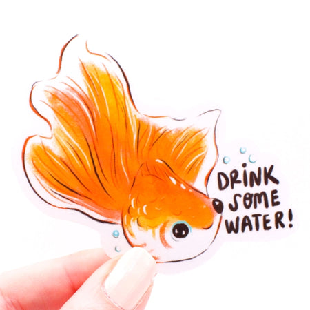 Sticker in the image of a goldfish with black text saying, “Drink Some Water”.