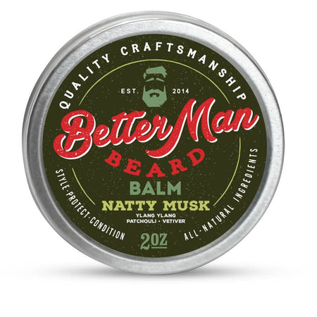 Round silver tin with black label with red and green text saying, “Better Man Beard Balm Natty Musk”. Image of a man with green hair and green beard in top center.