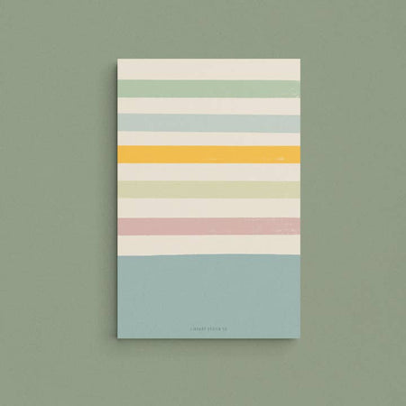 Teal pad with tan, green, teal, orange and pink horizontal stripes.