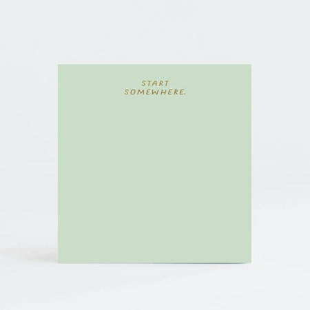 Green square pad gold foil text saying, “Start Somewhere” in top center.