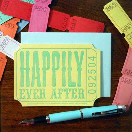 Yellow card in the image of a carnival ticket with blue text saying, “Happily Ever After”. Numbers in blue text on side reading, “092504”. A matching envelope is included.