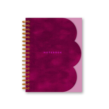 NOtebook with pink cover and pink velvet inlay with scalloped edge on right side. Pink text saying, 