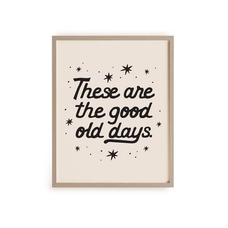 Art print with ivory background and black text saying, “These Are the Good Old Days”. Images of black stars scattered around.