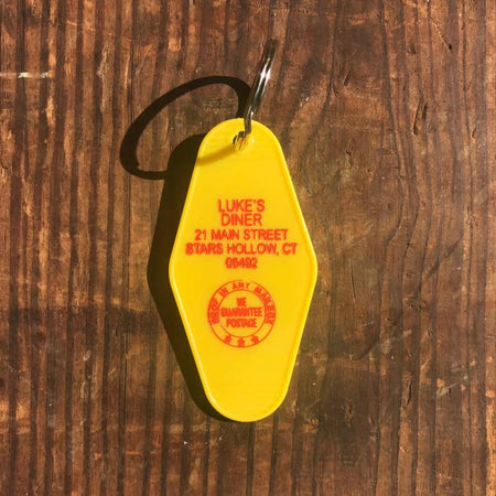 Yellow vintage style motel key fob with red text featuring Luke's Diner from Gilmore Girls.