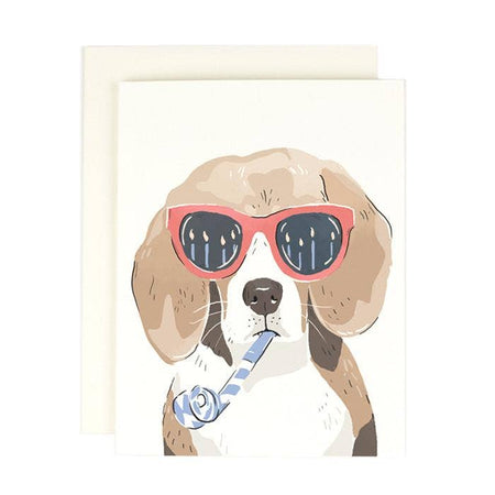 White card with image of a brown Beagle dog wearing red sunglasses and holding a blue party horn in its mouth. A white envelope is included.