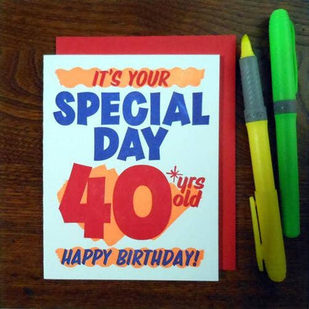 White card with red and blue text saying, “It’s Your Special Day 40 years old Happy Birthday!” Text designed to look like a grocery store special sale sign. A red envelope is included.