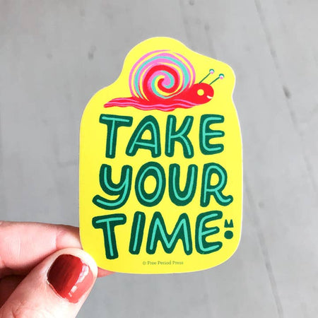 Yellow sticker with image of a red snail at the top. Green text saying, “Take Your Time”.