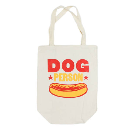 White tote bag with red and yellow text saying “Dog Person” with image of a hot dog in a bun.
