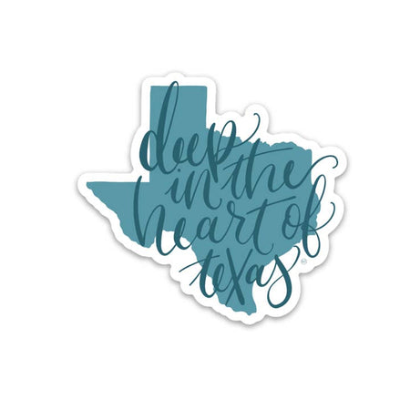 Blue sticker in the image of the state of Texas with blue script text saying, “Deep in the Heart of Texas”.