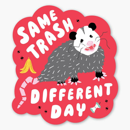 Pink sticker with image of a gray possum, yellow banana peel, apple core and black flies. White text saying, “Same Trash Different Day”.