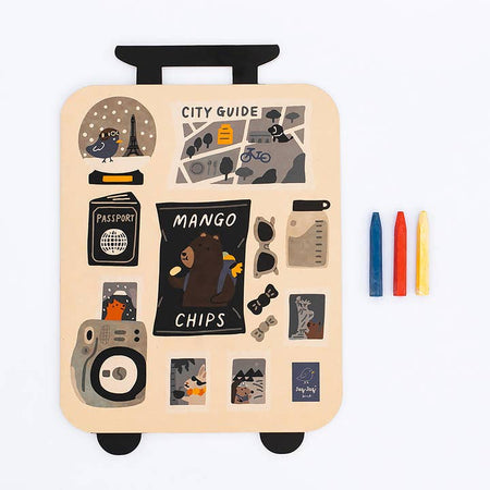 Coloring book shaped in the image of a rolling suitcase with a tan background and several travel stickers on the front. 