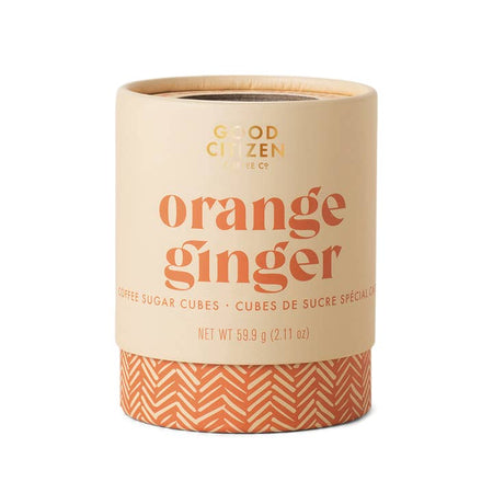 Light orange circle container with orange text saying, “Good Citizen Orange Ginger Sugar Cubes”. Orange swirl design on bottom of container.