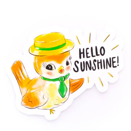 Sticker in the image of a yellow and white bird wearing a yellow hat. Black text saying, “Hello Sunshine”.