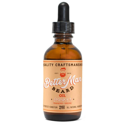 Small brown dropper bottle with orange label with brown and white text saying, “Better Man Beard Oil Franky T”. Image of a man with red hair and red beard in top center.