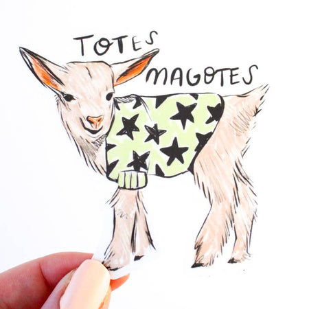Sticker in the image of a baby goat wearing a lime green shirt with black stars on it. Black text saying, “Totes Magotes”. 