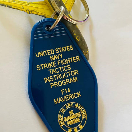 Blue vintage style motel key fob with yellow text featuring everyone's favorite (or not) movie, Top Gun.