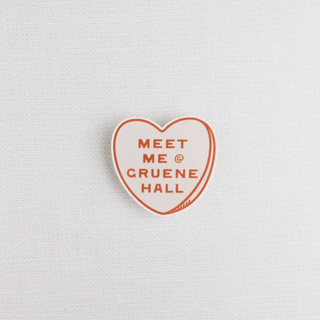 White heart with red border and red text saying, “Meet Me @ Gruene Hall”.
