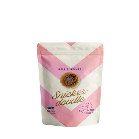 Snickerdoodle cookies packaged in a zip seal bag with pink and white chevron pattern stripes with blue and gold text saying, “Bell’s Reines Snickerdoodle”.