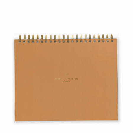 Orange notebook with gold foil text saying, 