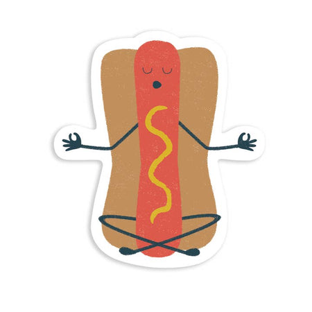 Sticker in the image of a red hot dog inside a bun with a stripe of yellow mustard down the center. Hot dog has closed eyes and open mouth, with arms and crossed legs in a meditation pose.