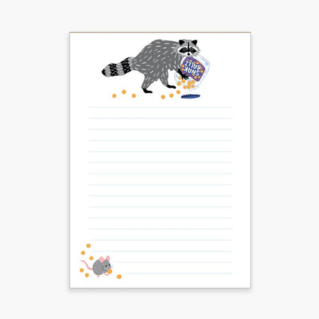 White notepad with image of a raccoon dumping a plastic bucket of cheese balls across top center. In bottom left corner is a gray mouse eating cheese balls.