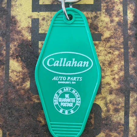 Green vintage style motel key fob with white text featuring the best auto parts supplier from the movie Tommy Boy.