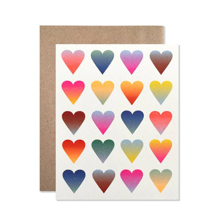 White card with images of small tiled hearts with gradient colors of red, pink, green, blue, yellow and orange.  A brown kraft paper envelope is included.