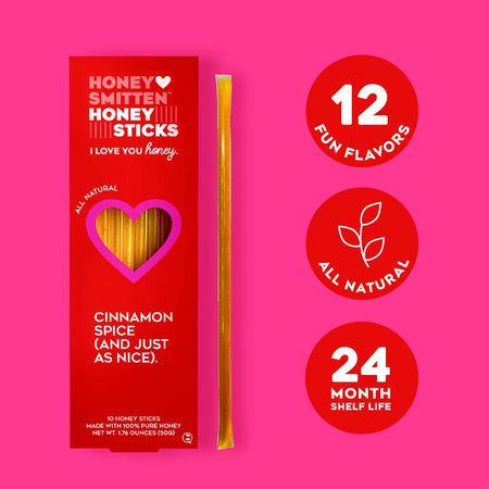 Honey sticks packaged in a vertical red box with a heart shape cut out in center. White text saying, “Honey Smitten Honey Sticks Cinnamon Spice”.