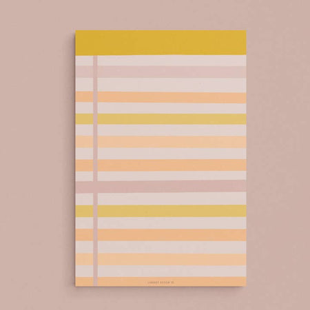 Legal pad with light pink background and pink, orange, yellow and white horizontal stripes.