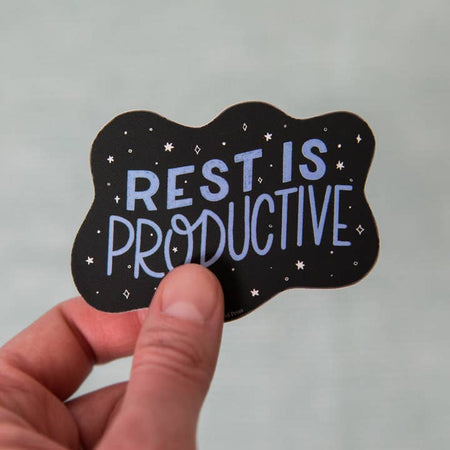 Black sticker with images of white stars and diamonds. Blue text saying, “Rest is Productive”.