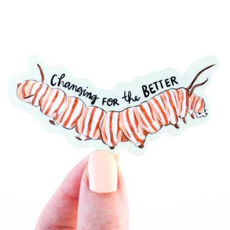 Sticker in the image of a striped caterpillar with black text saying, “Changing for the Better”.
