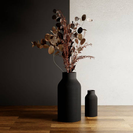 Black vase with vertical contoured lines.