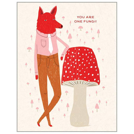White card with image of a red wolf wearing a pink shirt and brown pants; leaning on a red mushroom. Muted red mushrooms scattered in background. Red text saying, “You Are One Fungi!” A matching envelope is included.