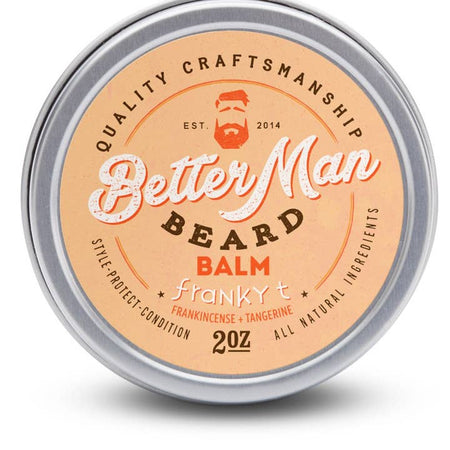 Round silver tin with orange label with brown and white text saying, “Better Man Beard Balm Franky T”. Image of a man with red hair and red beard in top center.