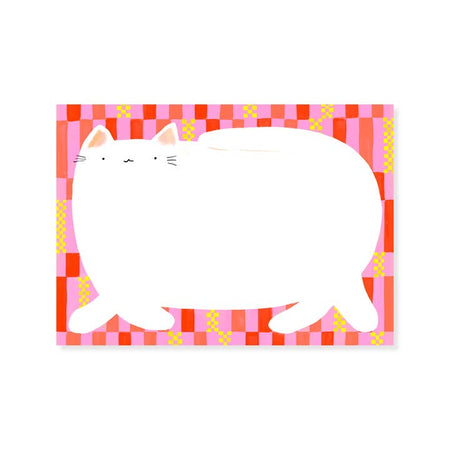 Notepad with pink and red checker pattern in background. Large white cat in foreground.