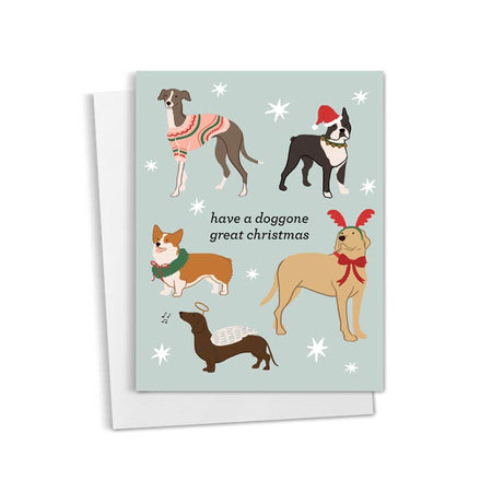 Blue card with black text saying, “Have A Doggone Great Christmas”. Images of different breeds of dogs wearing Christmas sweaters, Santa hats, reindeer antlers and angel wings. A white envelope is included.