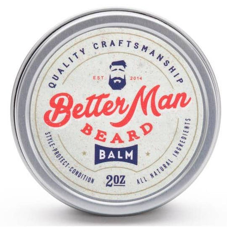 Round silver tin with white label with red and blue text saying, “Better Man Beard Balm”. Image of a man with blue hair and blue beard in top center.