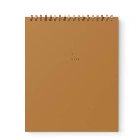 Orange notebook with gold foil text saying, 