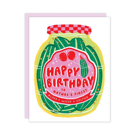White card with image of a large pickle jar in center with green pickles inside. Red and pink label on jar with red text saying, “Happy Birthday to Nature’s Finest: Older Wiser Saltier”. A matching envelope is included.