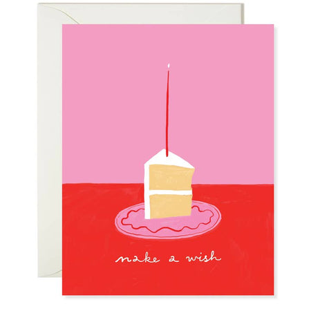 Pink card with red across bottom with image of a slice of vanilla cake on a pink plate with a red candle. White text saying, “Make A Wish”. A white envelope is included.