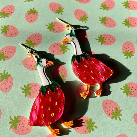 Set of earrings in the image 2 white geese with the bottom half of their bodies being red berries.