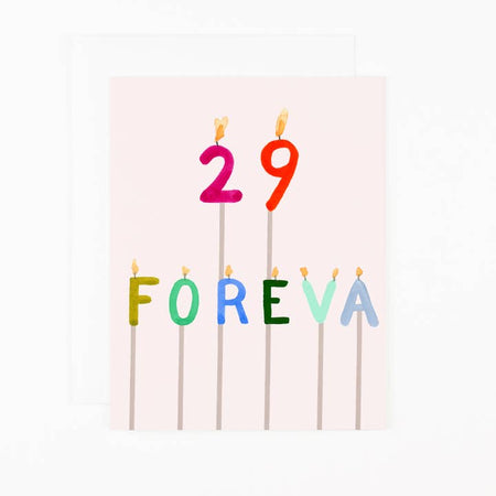 Pink card with colored number and letter candles on individual sticks saying, “29 FOREVA”. A matching envelope is included.