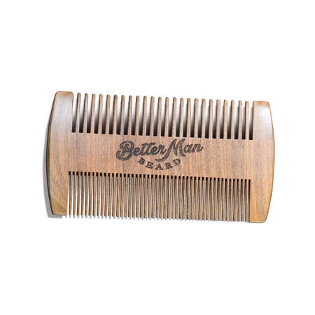 Double sided wooden comb with brown text carved in center saying, “Better Man Beard”. Comb teeth on bottom are close together and comb teeth on top are further spread apart.