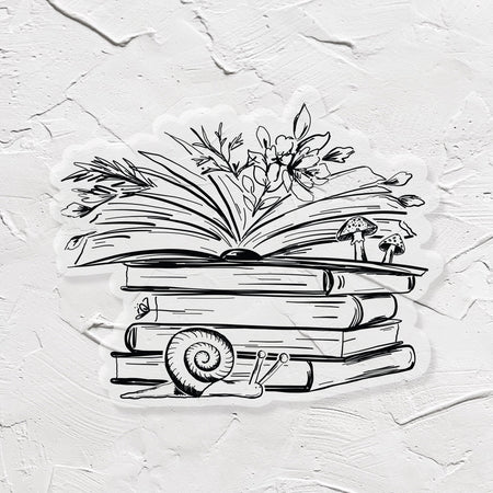 Black and white sticker in the image of a stack of books with greenery coming out of top open book. Snail in front of pile.