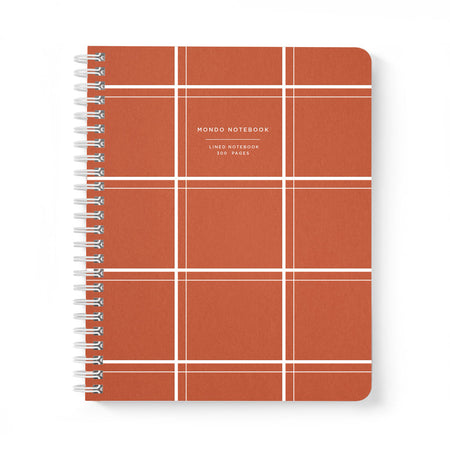 Orange cover with white square gridlines. Box in top center with white text saying, “Mondo Notebook Lined Notebook”. Silver coil binding on left side.