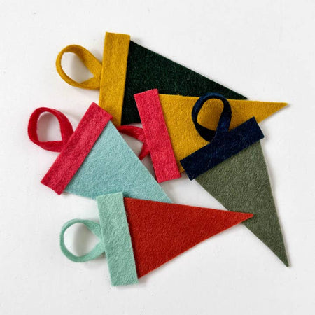 Mini felt pennants in classic colors with custom white text saying, “San Antonio”. 
