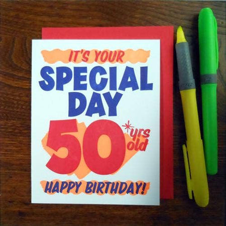 White card with red and blue text saying, “It’s Your Special Day 50 years old Happy Birthday!” Text designed to look like a grocery store special sale sign. A red envelope is included.