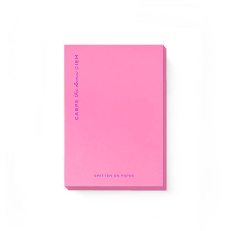 Pink notepad with neon purple text saying, 