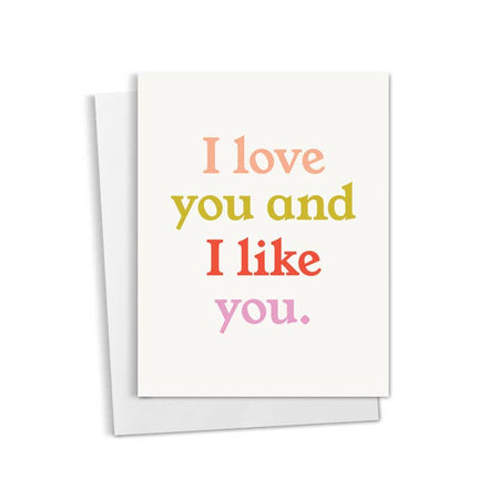 White card with pink, green, red and purple text saying, “I Love You and I Like You”. A white envelope is included.